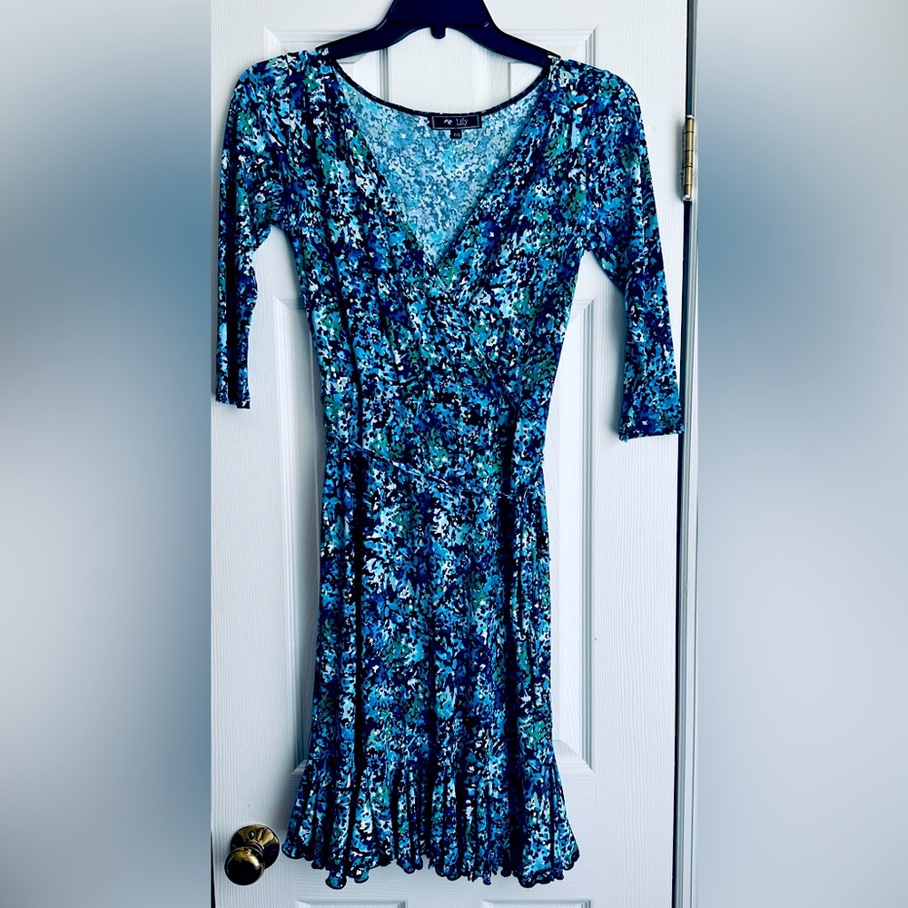 Beautiful dress by Lilly with waist tie, ruffle bottom and length at knee
